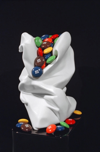 hyper-realistic stone sculpture of M&M's in a white bag by Robin Antar