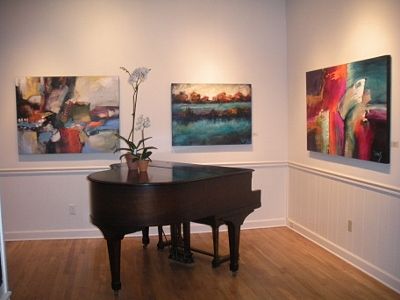 Grand Piano and artwork at a gallery