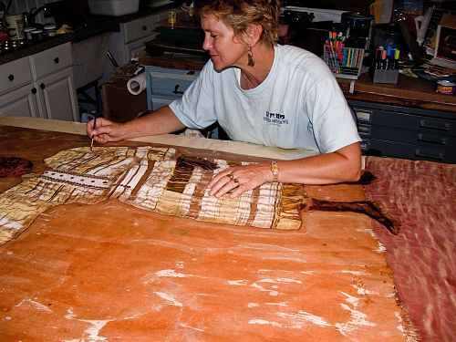 artist works on a batik