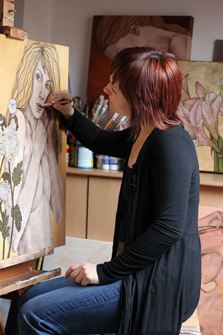 artist painting a portrait in the studio