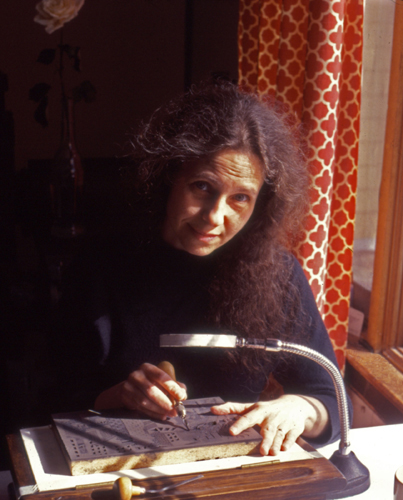 Artist Karen Whitman cutting linoleum