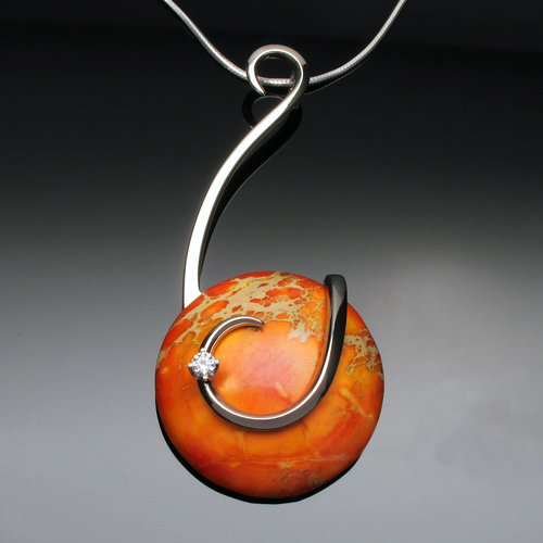 "Sunset Glow" Pendant, Sterling Silver Fork Tines, Orange Veriscite Cabochon, 3” x 2” x 1” by artist Don Kelley. See his portfolio by visiting www.ArtsyShark.com