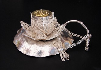 “Darling, Lotus, have some tea...” Silver and Gold Teacup, Saucer and Infuser, 5” x 4” x 2 ½” by artist Victoria Lansford. See her portfolio by visiting www.ArtsyShark.com