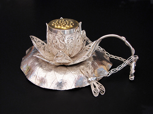 “Darling, Lotus, have some tea...” Silver and Gold Teacup, Saucer and Infuser, 5” x 4” x 2 ½” by artist Victoria Lansford. See her portfolio by visiting www.ArtsyShark.com