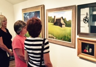 Shoppers at an art gallery. Read how artists can partner with galleries to sell work more effectively at www.ArtsyShark.com