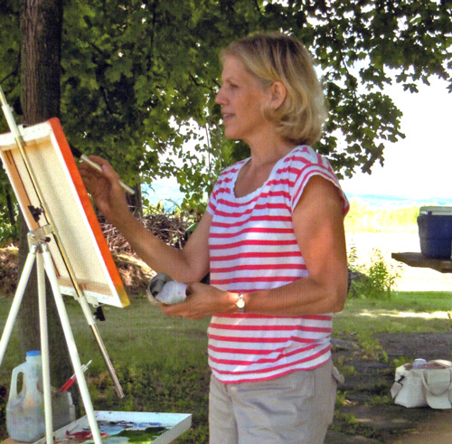 Artist Kathy Armstrong works en plein air on a painting. See her feature at www.ArtsyShark.com
