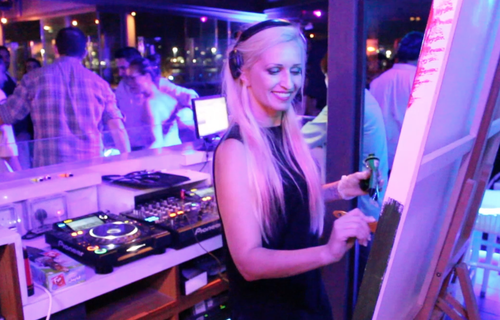 Sabrina Terence paints during a dance party.