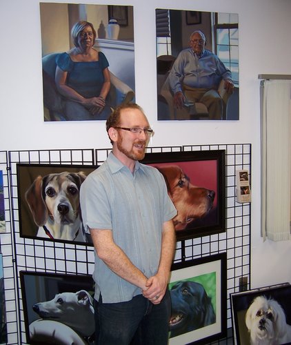 Painter and teacher Glen Kessler speaks about his art at a gallery opening.