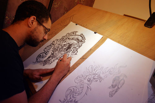 Artist Alasdair Roy from Dark Design Graphics creates a custom tattoo design.