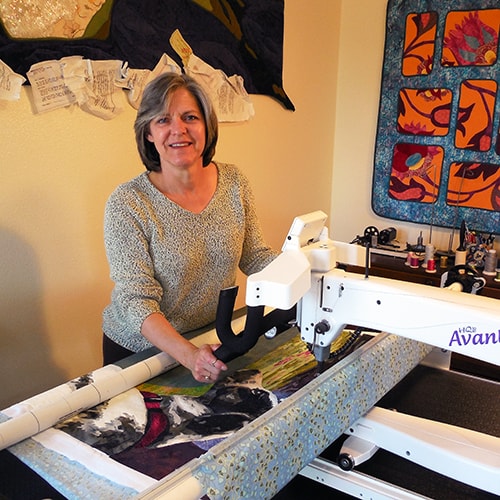 Artist Lea McComas at the longarm sewing machine. See her portfolio by visiting www.ArtsyShark.com