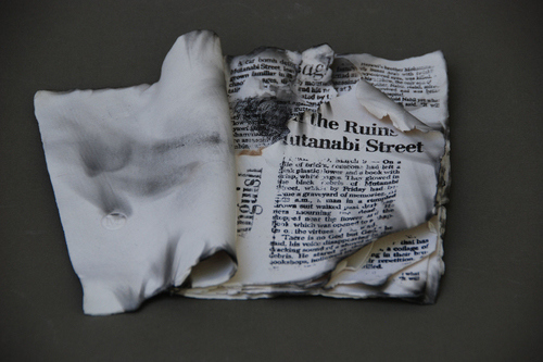 Porcelain Printed Book from “Living Without Them” Installation, Porcelain with Newspaper Transfer, 9" x 6" x 2" by artist Lilianne Milgrom. See her portfolio by visiting www.ArtsyShark.com
