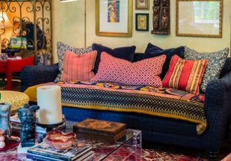 Room filled with art in a Bohemian style, designed by Carol Marcotte. Read her interview at www.ArtsyShark.com