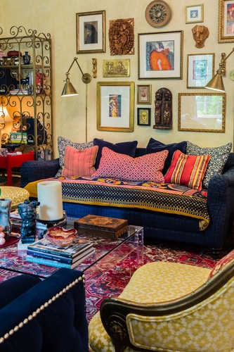 Room filled with art in a Bohemian style, designed by Carol Marcotte. Read her interview at www.ArtsyShark.com