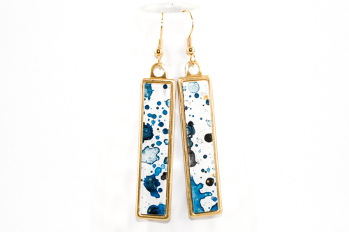 Splatter Painted Dangle Earrings—Acrylic Paint on Clear Acrylic, Brass Setting, 2” x 1/2” by artist Sarah Mandell. See her portfolio by visiting www.ArtsyShark.com