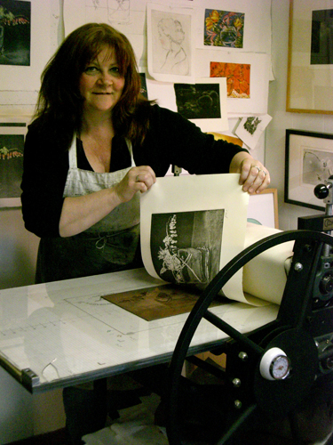 Artist Jayne Reid Jackson in her studio, pulling a proof. See her portfolio by visiting www.ArtsyShark.com