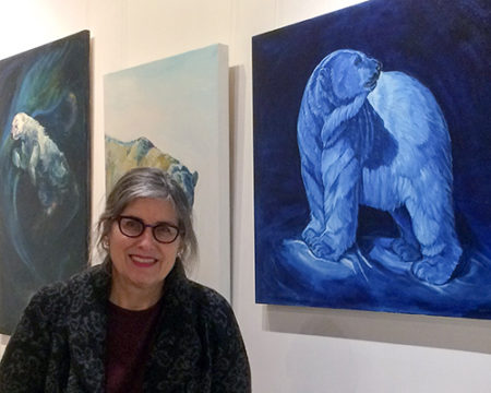 Artist Christine Montague with one of her polar paintings. Read about art for a cause at www.ArtsyShark.com