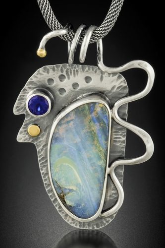 “Boulder Opal Alchemy” Boulder Opal, Lolite, Sterling Silver and 18 kt Gold, 1.25" x 1.5" x .25" by artist Dawn Middleton. See her portfolio by visiting www.ArtsyShark.com