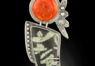 “Pele Rising” Red Sponge Coral, Chinese Writing Stone, White Topaz stone and Sterling Silver, 1.5” x 3.5” x .5” by artist Dawn Middleton. See her portfolio by visiting www.ArtsyShark.com