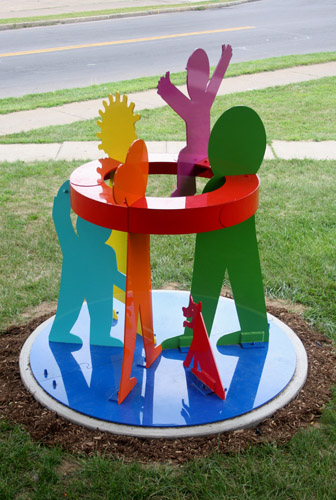 “Community as Family” (Beauchamp Library, Syracuse, NY) Painted Aluminum, 6’ x 6’ x 6’7” by artist Peter Michel. See his portfolio by visiting www.ArtsyShark.com 