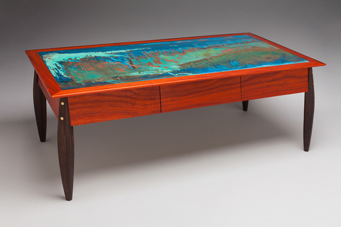 “Robbie’s Table” Table with Wenge Legs, Paduak Body and Trim with Patinated Copper Top, 18” x 40” x 15” by artist Peter Judge. See his portfolio by visiting www.ArtsyShark.com