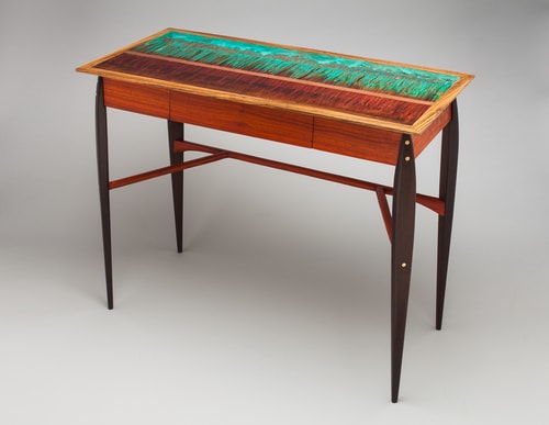 “Fire Below” Writing Desk with Wenge Legs, Paduak Stretchers and Body and Zebrawood Trim with Patinated Copper Inlay, 16” x 40” x 29” by artist Peter Judge. See his portfolio by visiting www.ArtsyShark.com