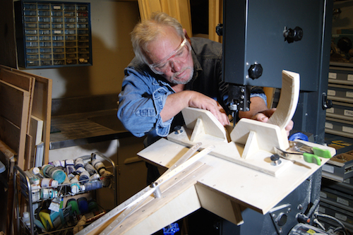 Artist Kurt Wedgley in his studio cutting pieces on a custom jigsaw. See his portfolio by visiting www.ArtsyShark.com