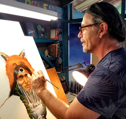 Artist Shel Waldman painting Native American-inspired art in his studio. 