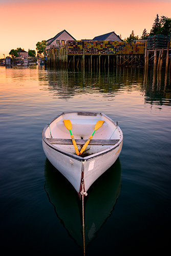 Striking sunset photo of a dory in Bernard Harbor by Rick Berk.