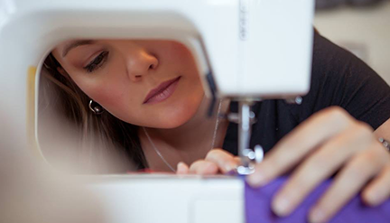 Artist Erin Bassett works on production in her studio.