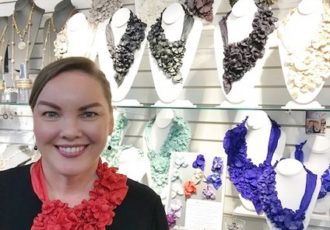 Erin Bassett presents her handmade accessories at a trade show in Atlanta.