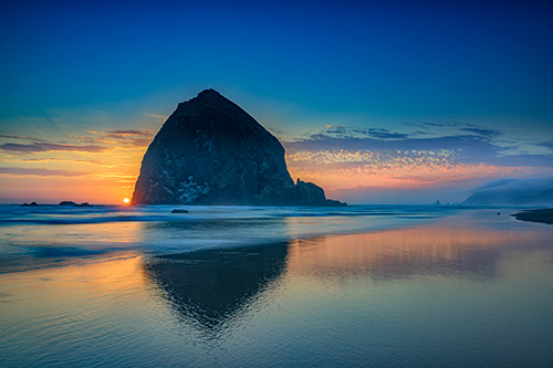 Sunset at Cannon Beach Photograph by Rick Berk.
