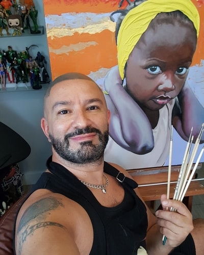 Artist Leonardo Montoya in his studio with a piece from his "Life Bearers" Collection. See his portfolio by visiting www.ArtsyShark.com