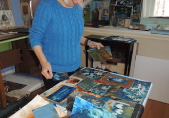 Artist Lesley Riley working with cyanotype prints in her studio