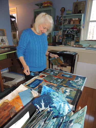 Artist Lesley Riley working with cyanotype prints in her studio