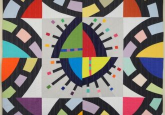 Kaleidoscope patterned quilt by Cindy Grisdela