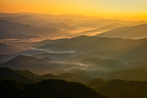 Photograph of the Smoky Mountains mist at sunrise over Brasstown Bald by Andy Crawford