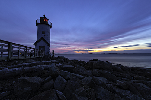 Photograph of the sunset over the Annisquam Lighthouse in Gloucester, Massachusetts by Cheryl Harris