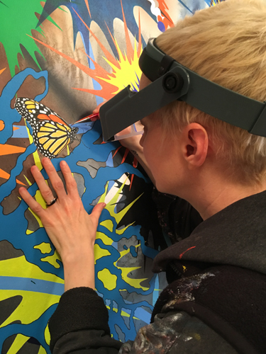 Artist Kara Maria at work on a painting