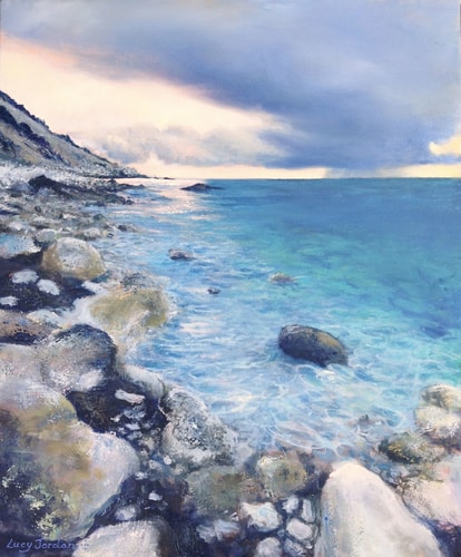 Painting of a rocky beach scene of a sunset at Gialos Skala Beach in Greece by Lucy Jordan