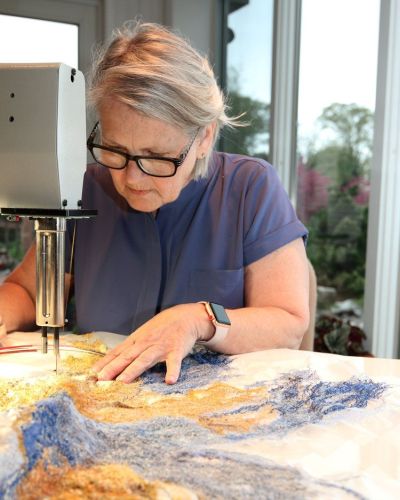 Artist Carla Fisher at work in her studio