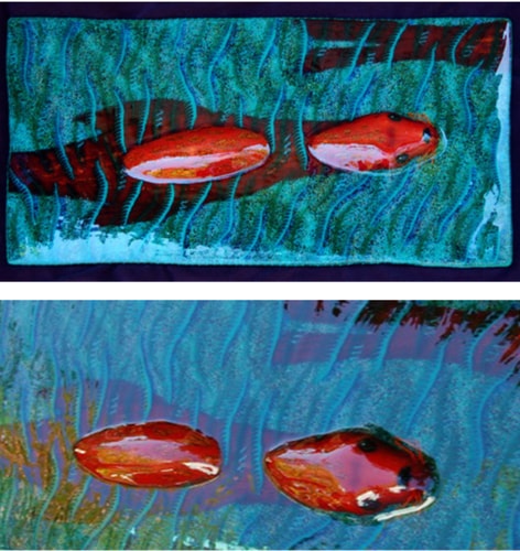 Glass artwork showing red seals in the water by Michael Dupille