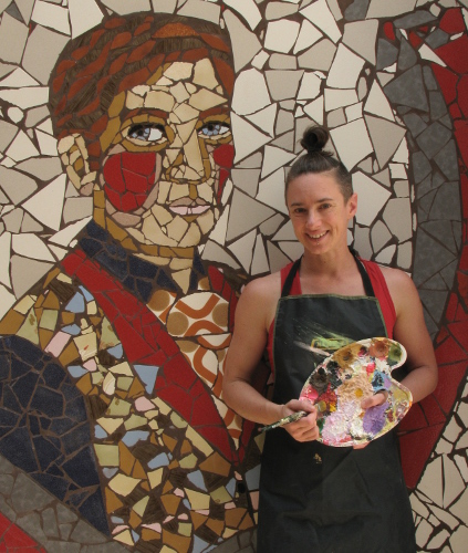 Artist Irene Raspollini in front of one of her tile murals