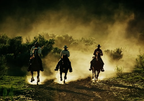 Photograph of three cowboys on horseback by Christopher Marona