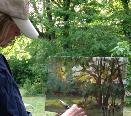 Artist Dot Courson painting plein air in her backyard