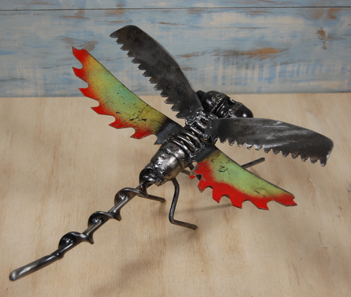 Reclaimed metal sculpture of a dragonfly by Christian Schoenig
