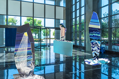 Lobby exhibit of several acrylic on MDF sculptures by Andrea Shearing “Moving Water”