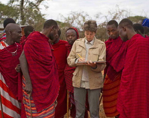 Artist Alison Nicholls sketching in a Maasai homestead in Tanzania