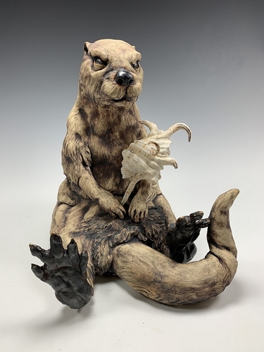 Stoneware and found object sculpture of an otter with a shell by Deana Bada Maloney