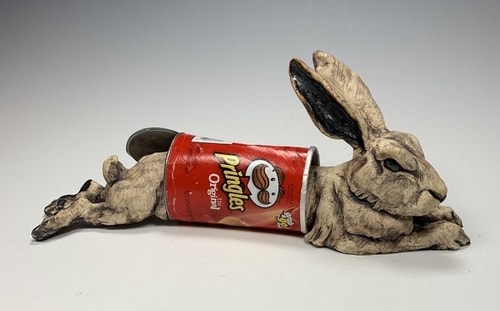 Stoneware and found object of a rabbit stuck in a Pringle's can by Deana Bada Maloney