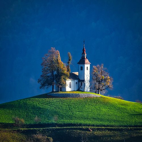 photograph of an old church on a hill